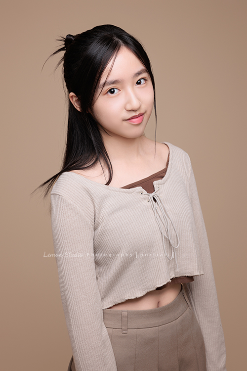 15歲的妤和姊姊分別來拍個人寫真紀念，今天分享的是妤的相片，這張是妤很輕鬆自在地站著、對著鏡頭微笑的一張很美的個人寫真照！