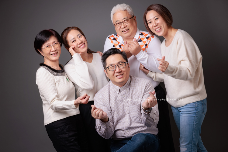 Justin爸拔和兄弟姊妹帶著各自的家庭、及爺爺奶奶一起來拍家庭攝影，雖然大家都以各自成家，三代聚在一起好熱鬧，各種組合是一定都要拍的，這張是Justin和姐妹們、及爸爸媽媽原生家庭的一家人的全家福！大家都很俏皮地擺出愛心！