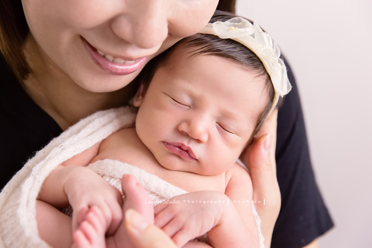 Diana媽麻和先生帶著剛出生的寶寶來拍新生兒攝影，外國人的爸拔和媽麻一起抱著寶寶，三人之間的互動自然又真摯，這是他們第一次的全家福，也是送給寶寶最有溫度美好的出生禮物，這張是媽麻將寶寶抱在胸前、看著寶寶微笑的幸福模樣！