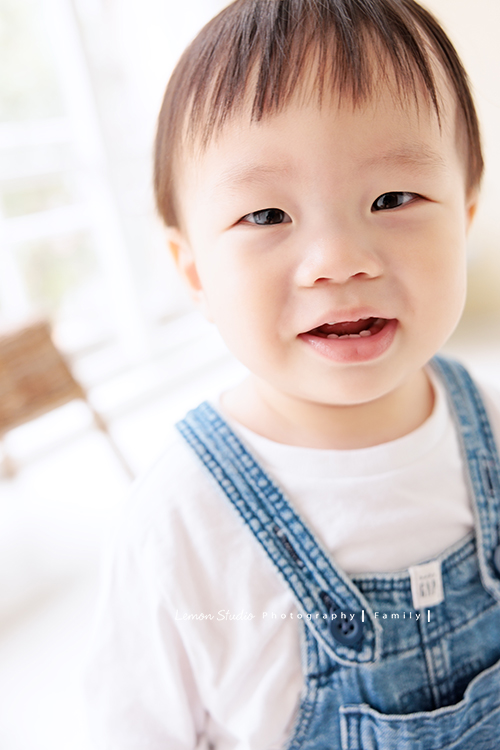 Ida媽麻一家第三次來拍照，四歲半和一歲半的姊弟倆，笑容與童趣洋溢，爸拔媽麻也陪著一起玩得很開心，這張是弟弟看著鏡頭可愛地微笑著的弟弟的個人寶寶寫真特寫！