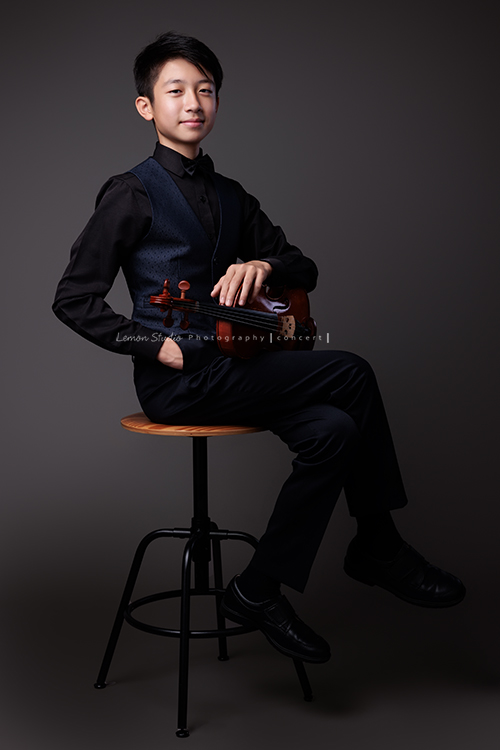 Alston為了音樂會演出，帶著小提琴來拍照，換上襯衫與西裝背心後，整個人一下子成熟了許多，沉穩又帶點小紳士的氣質，這張是Alston坐在椅子上、一手扶著提琴、一手放在口袋內，微笑地看著鏡頭帥氣音樂寫真！