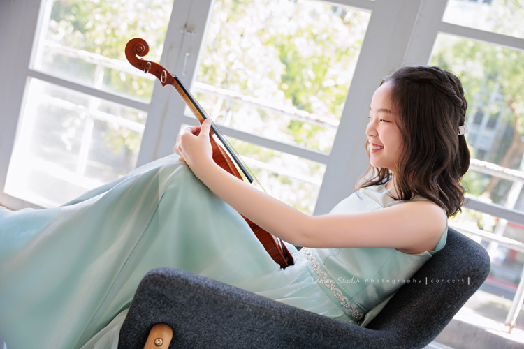 這是 Audrey 第三次來拍音樂會寫真,今年的她,又長大了一些,越來越美,也越來越有屬於自己的氣質,這張是Audrey穿著淡綠色的小禮服,坐在窗邊的椅子上看著放在腿上的小提琴微笑著的一張很美的小提琴音樂會寫真!