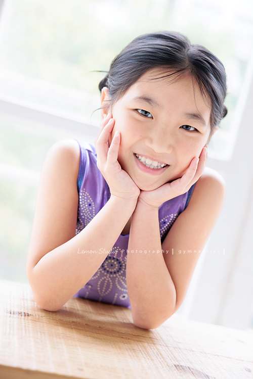 Vivien媽麻一家幾乎每年都會來拍照,三個孩子都在自己喜歡的領域裡成長著,這次小妹 Tiana帶著體操服來拍照,這張是Tiana穿著體操服兩手托著下巴兩側,笑容很燦爛地看著鏡頭,是一張很可愛的體操運動寫真!